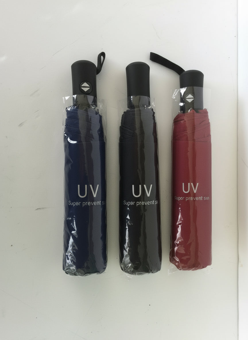 Three folded umbrellas in red, black, and blue with 'UV' text on a white background.